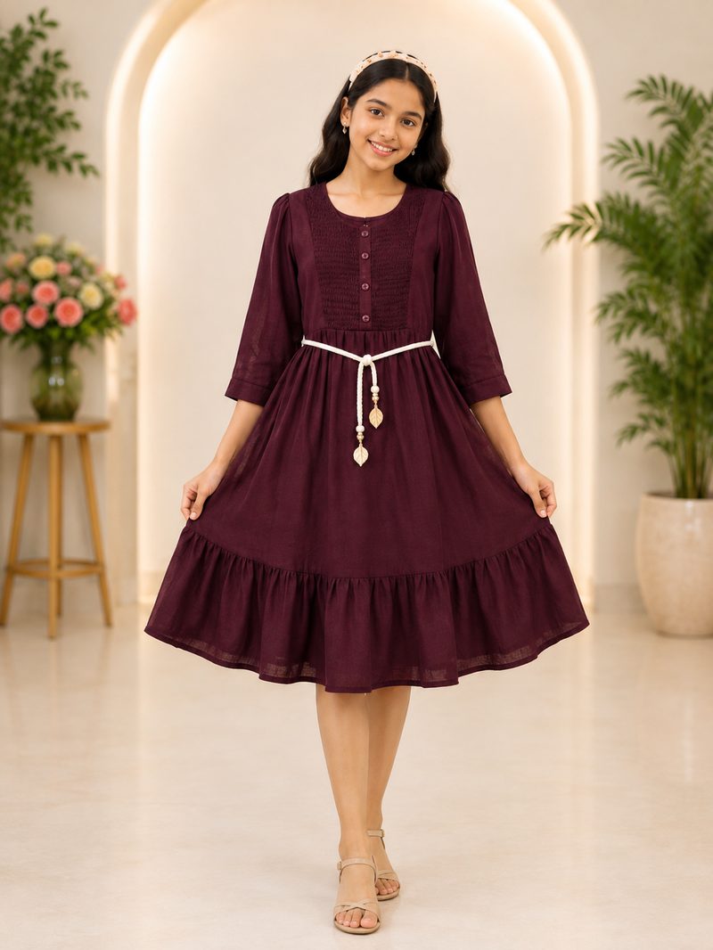 Girl wearing wine coloured tiered dress with rope belt